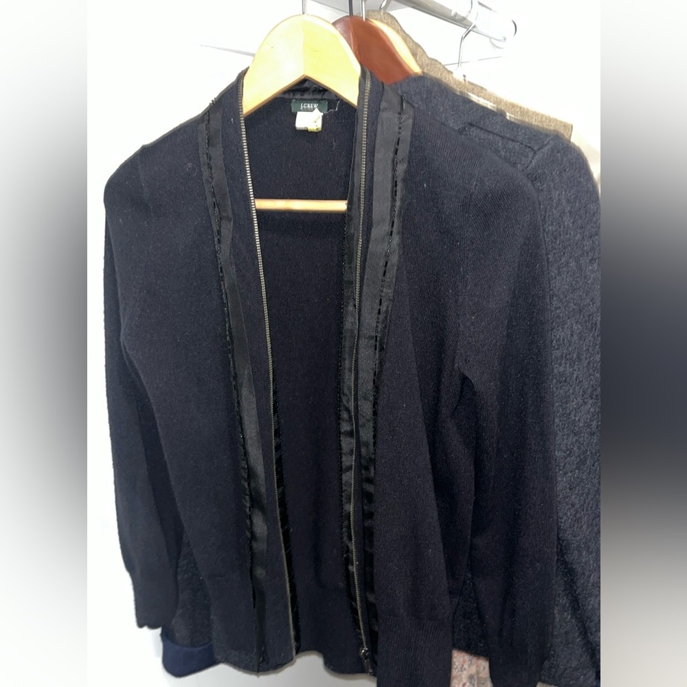 Is a J.crew brand, black sweater with beads and is 55% wool